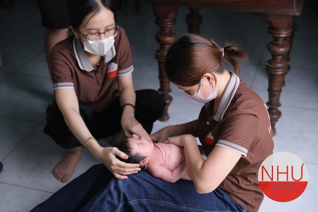 Hai người cùng đỡ bé, nguyên tắc an toàn khi chụp ảnh sơ sinh